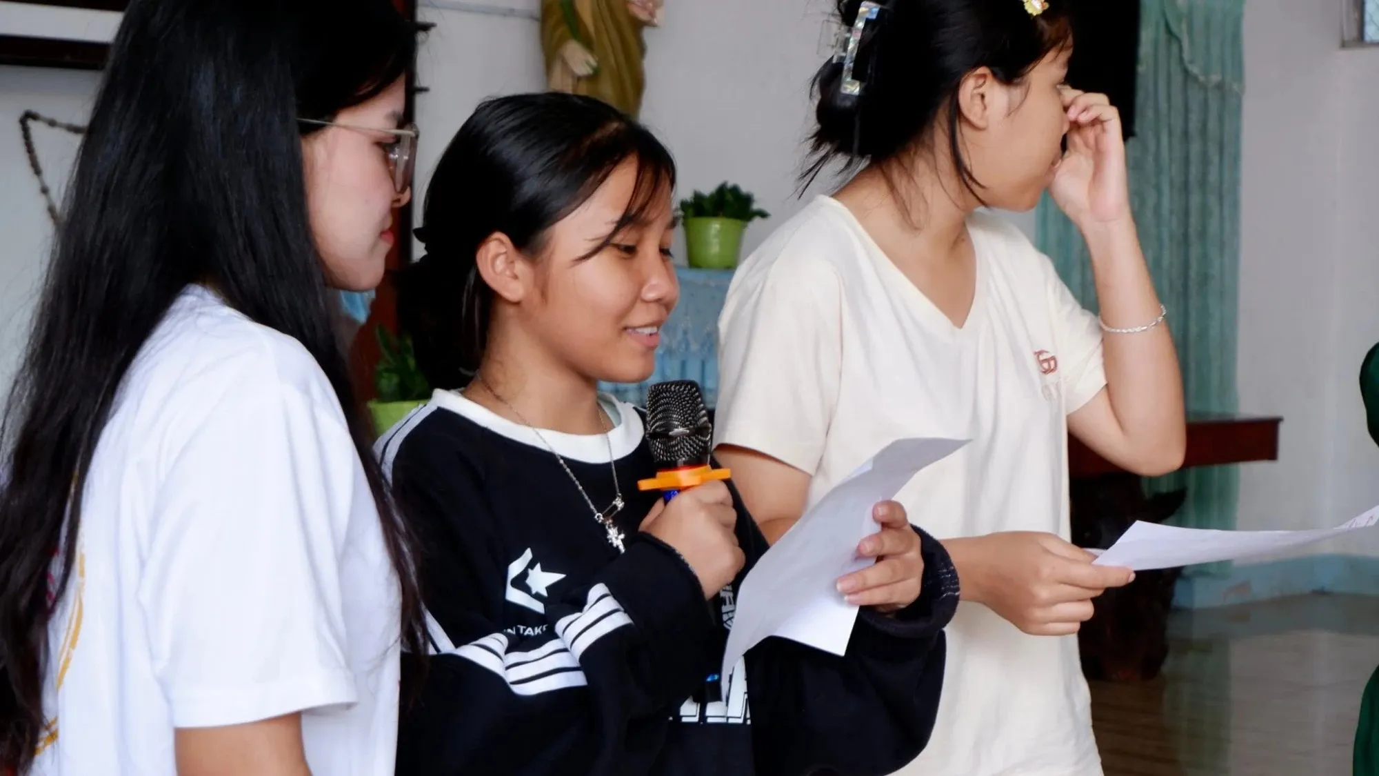 Students reading out their work with a microphone