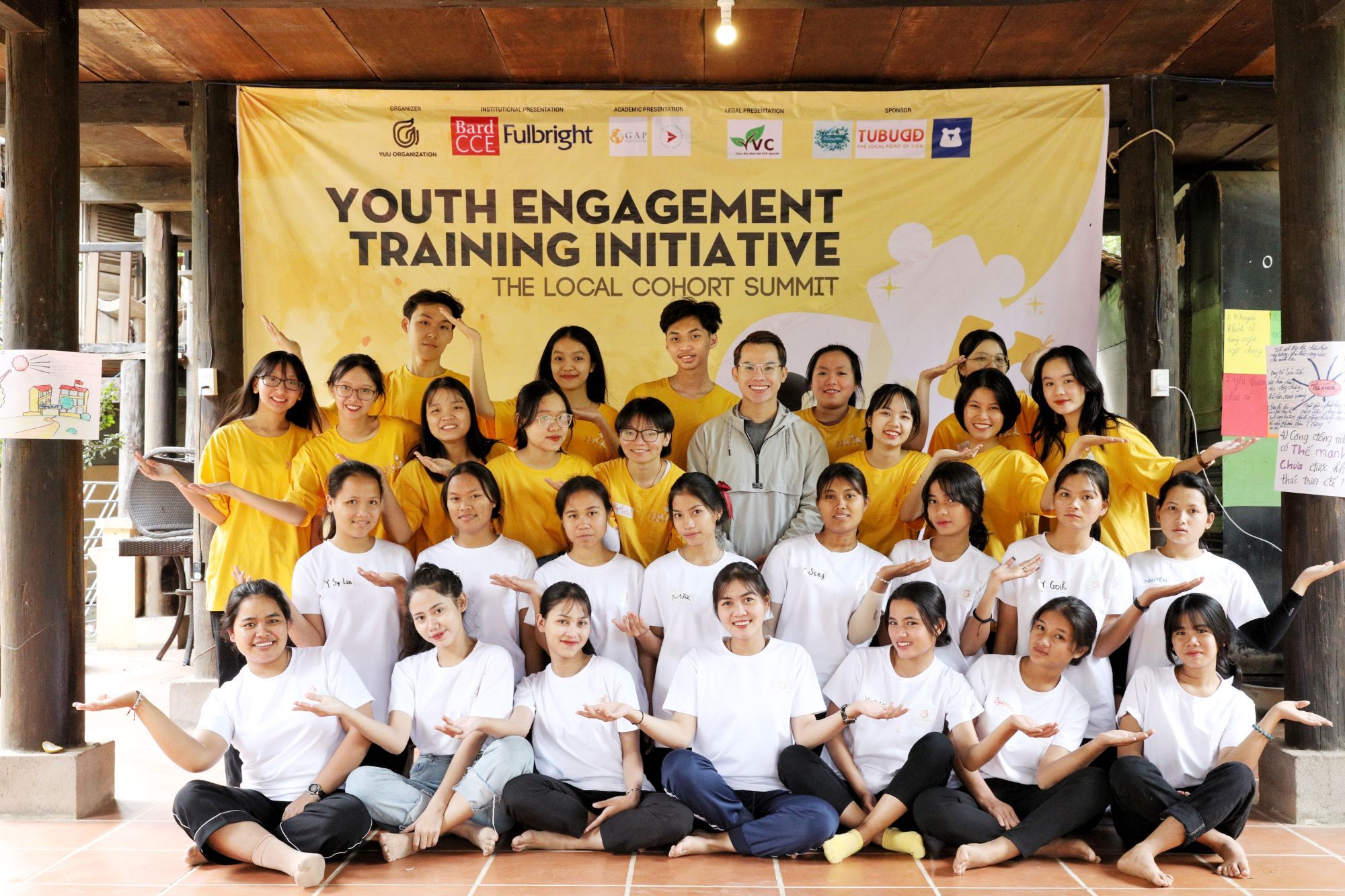 YETI students and facilitators with a village elder and his gongs in the forest in Kon Tum